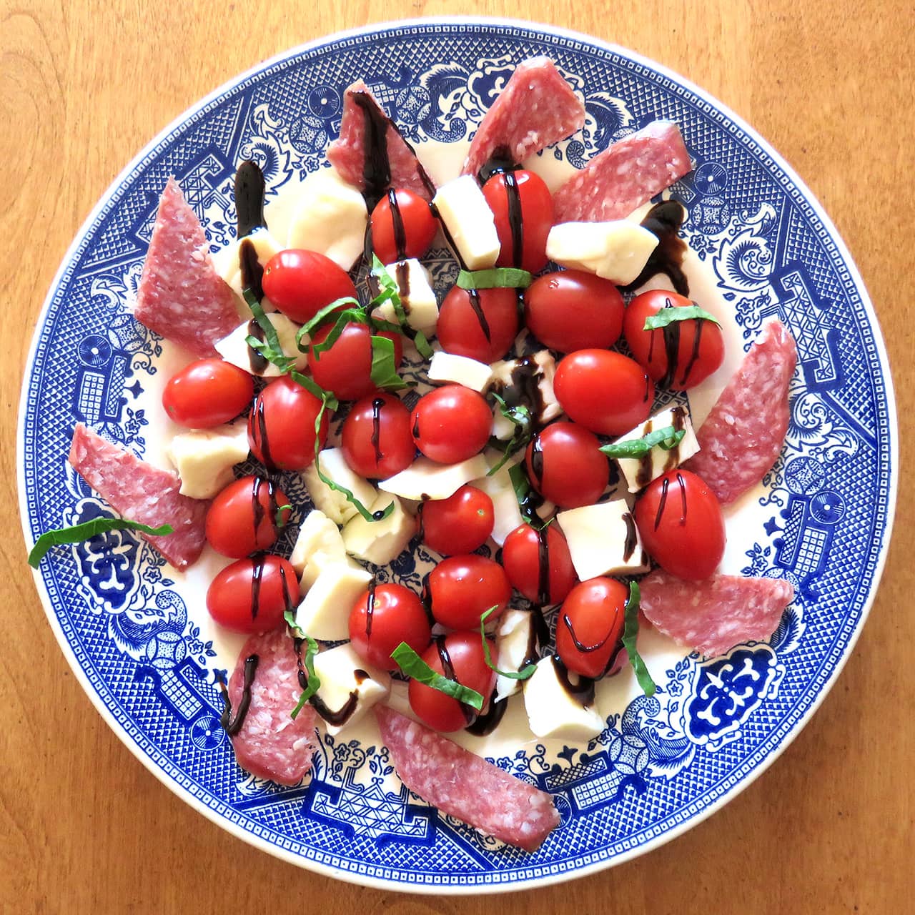 Tomato & Mozarella Salad Featuring Tusanini Balsamic Glaze