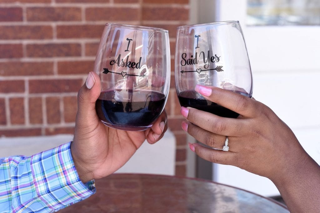 Couple Toasting Their Engagement - Let’s Get Hitched: The Things To Think About To Help You POP The Question