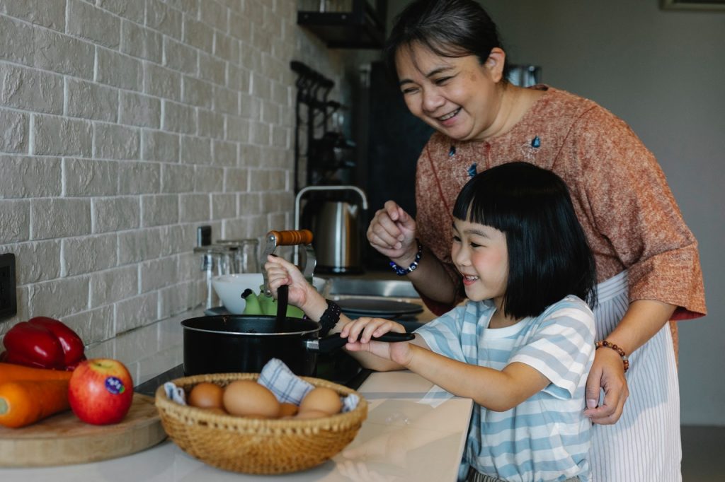 Grandmother with her granddaughter in the kitchen