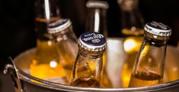 Close-up of chilled beer bottles in an ice bucket, perfect for bars and parties.