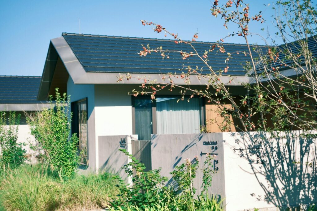Contemporary minimalist home exterior featuring lush garden and modern architecture.
