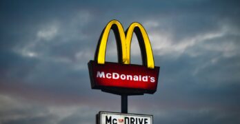 a mcdonald's sign with a cloudy sky in the background