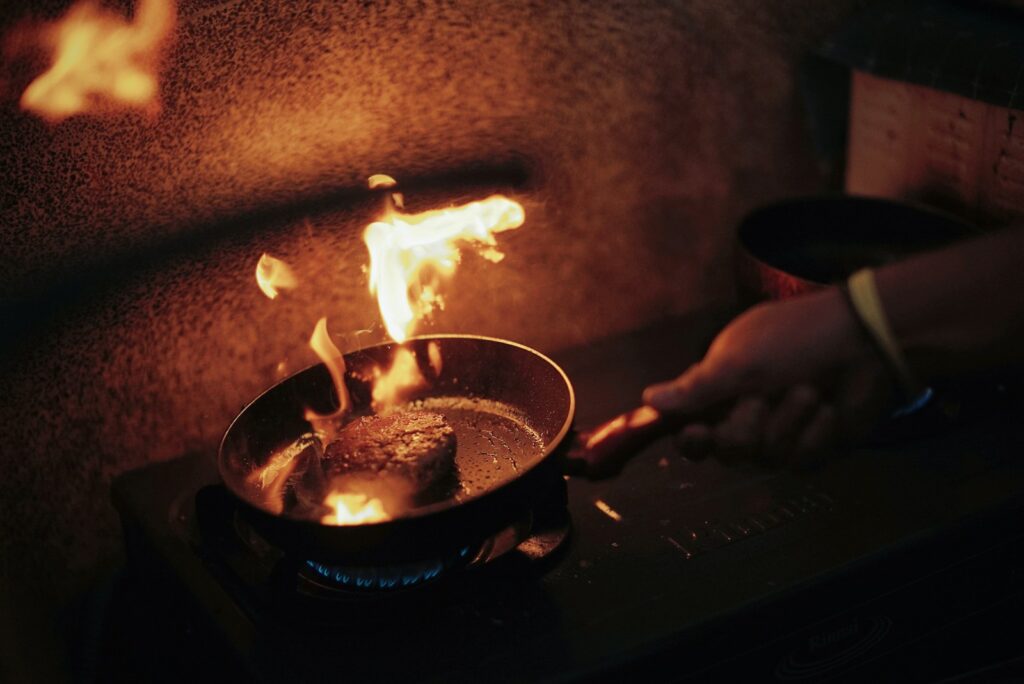 person holding frying pan