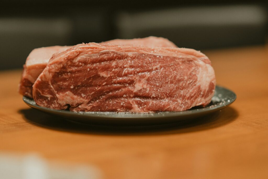 A piece of meat on a plate on a table